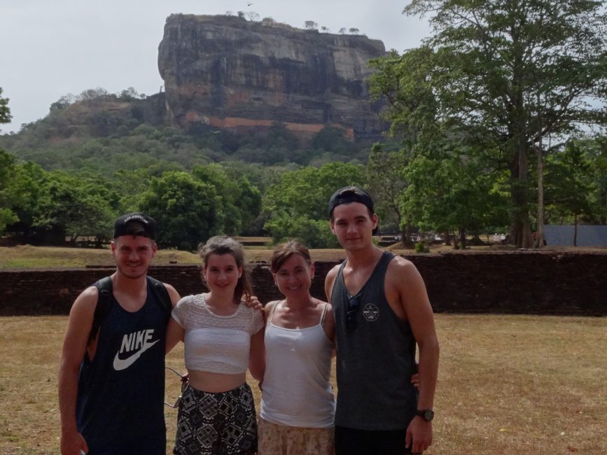 Tourists stand in front of Sigiriya Lion Rock which is a popular destination in Sri Lanka. Itโs a world heritage site.
