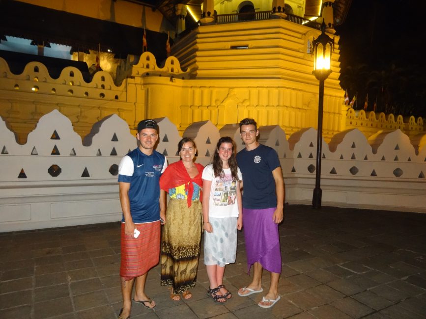 Wearing sarongs outside Temple in Kandy, Sri Lanka