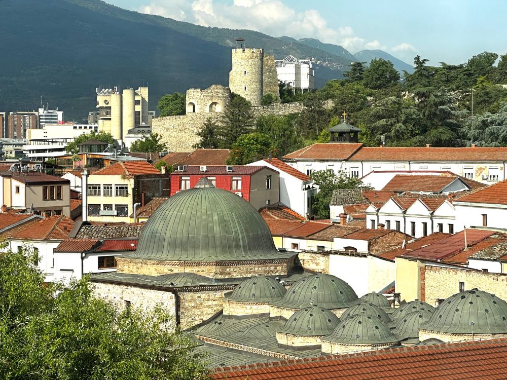 Fortress walls and mosque domes along with red tiles roofs of Skopje.