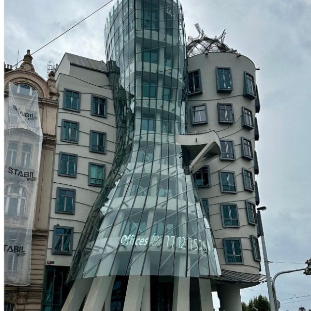Dancing House is a tall glass structure that is designed to show motion.  It is one of the newer attractions in Prague with a rooftop bar.