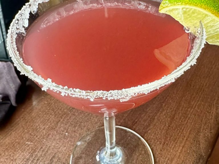 A martini raspberry cocktail with a sugar rim. Can be found in 5th Avenue Grill, One of the best happy hour places in Frisco.