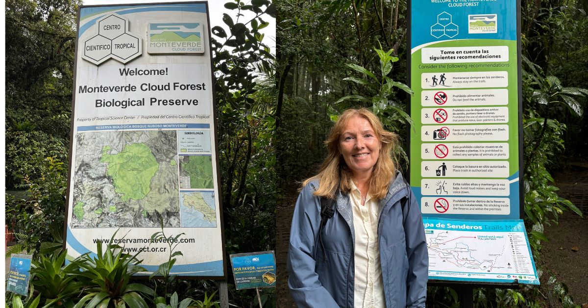 Information boards at Monteverde Cloud Forest with trail information.  Woman standing next to the boards.
