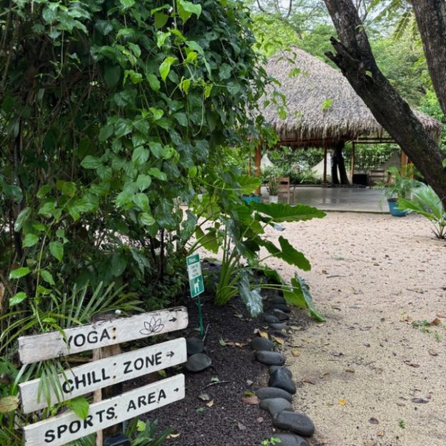 Signs to a thatched roof yoga studio at El Manglar Hotel Playa Grande Costa Rica.