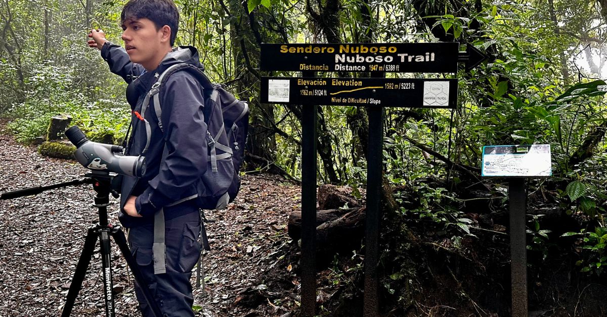 Guide in the cloud forest in Monteverde with a sign showing the forest trails you can take. 
