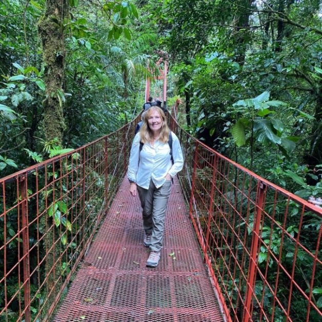 Crossing a hanging bridge in Monteverde Cloud Forest.