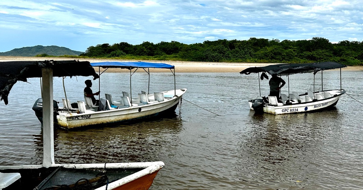 Small boats moored and waiting for passengers at Playa Grande Beach River Estuary.