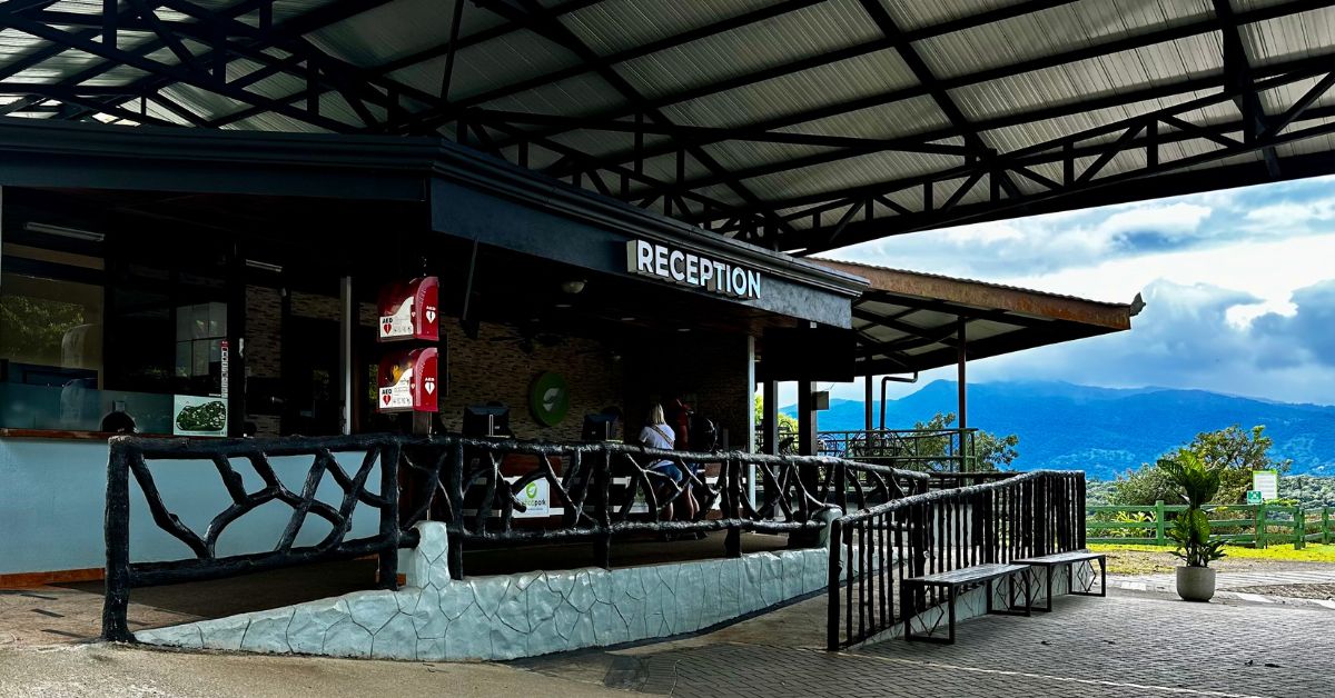 Reception Building at Mistico Hanging Bridges Park. View of volcano and hills in the background.