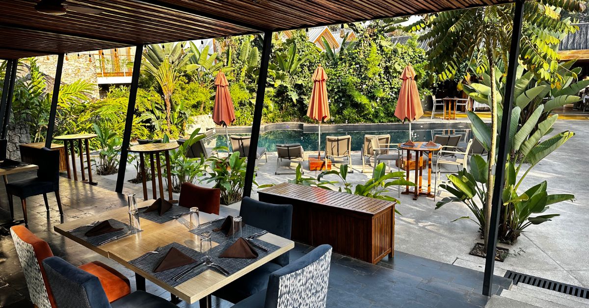 Outdoor dining area next to a swimming pool.