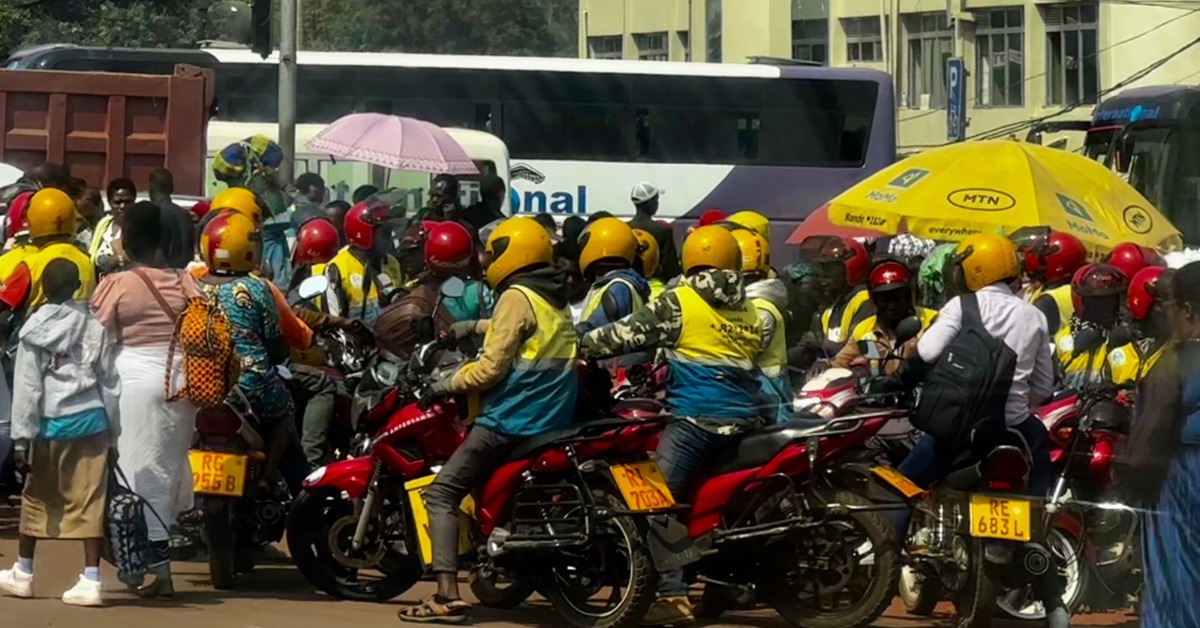 Taxi drivers on motorcycles wait for passengers.