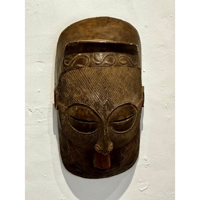 Traditional Rwandan Mask hanging on a Wall.