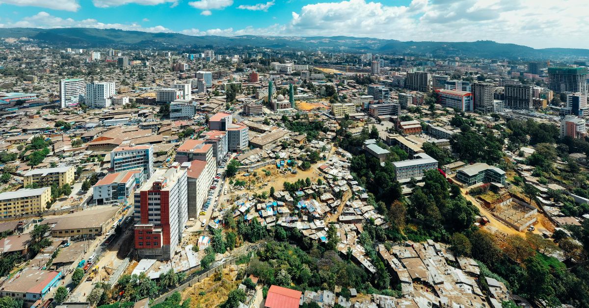 A mix of multi-story and poor areas of housing in Nairobi Kenya shown from high elevation. Green Hills are in the background