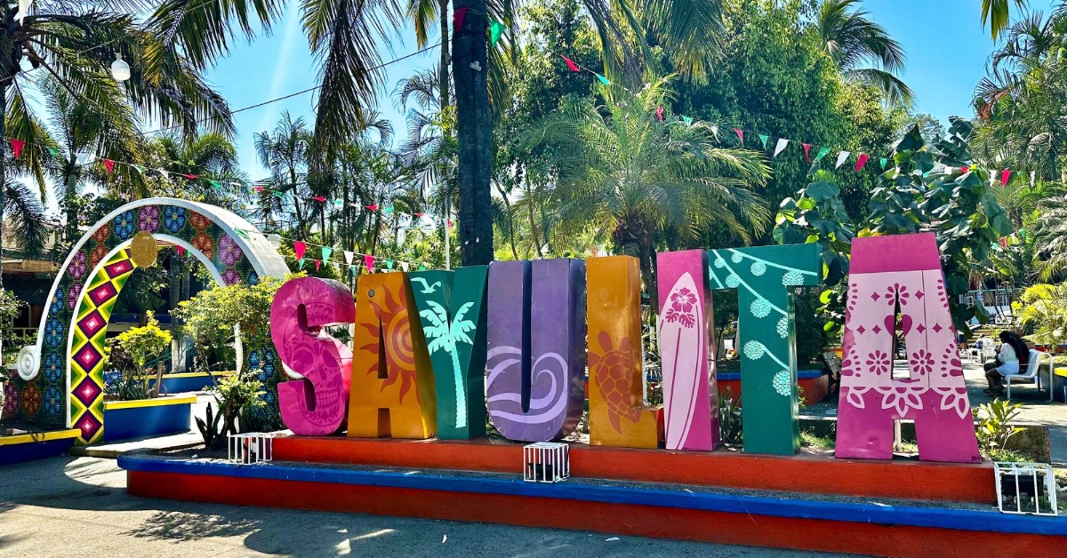 A large multi colored sign in the main Plaza with the lettering SAYULITA.