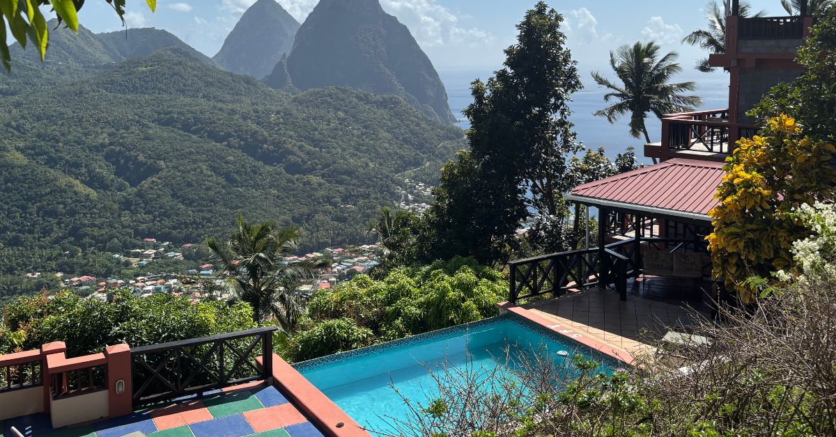 Lodgings very high up with a small swimming pool looking over the town of Soufriere and with the mountains in the background
