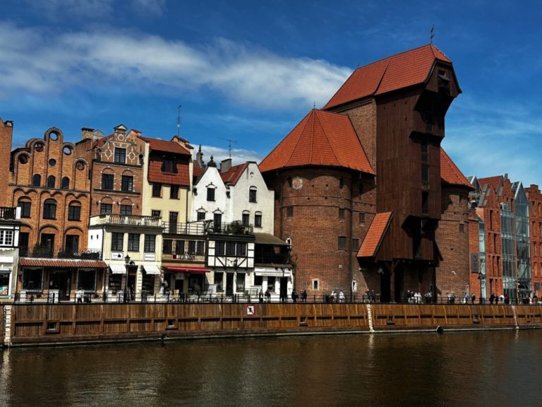 View of Wooden Crane and row of multi-coloured buildings on Gdansk.