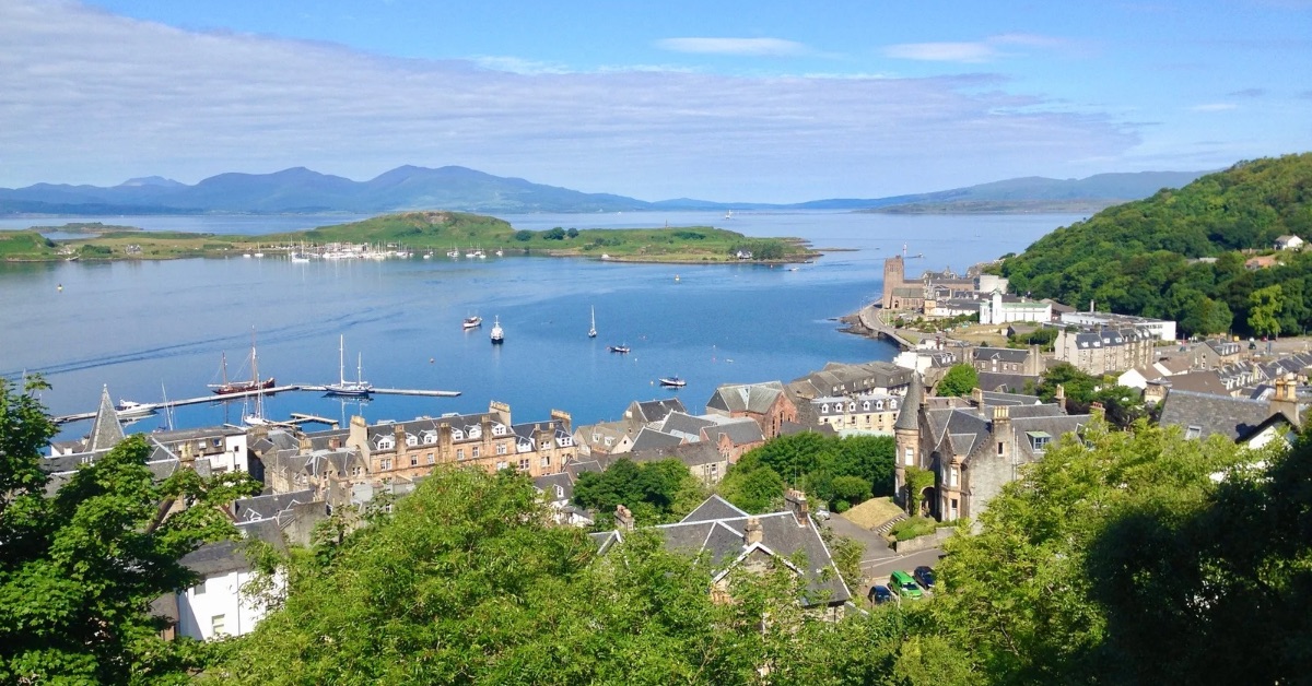 View of Oban showing boats moored in the bay and in the distance several islands.