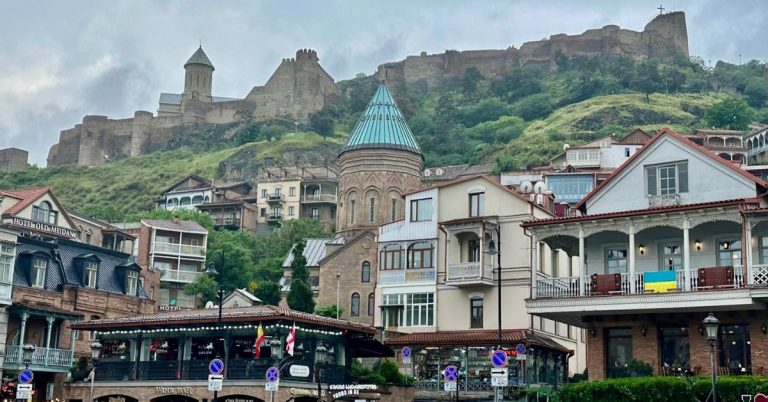view of old Tbilisi city showing ancient fortress on a hill behind the town.