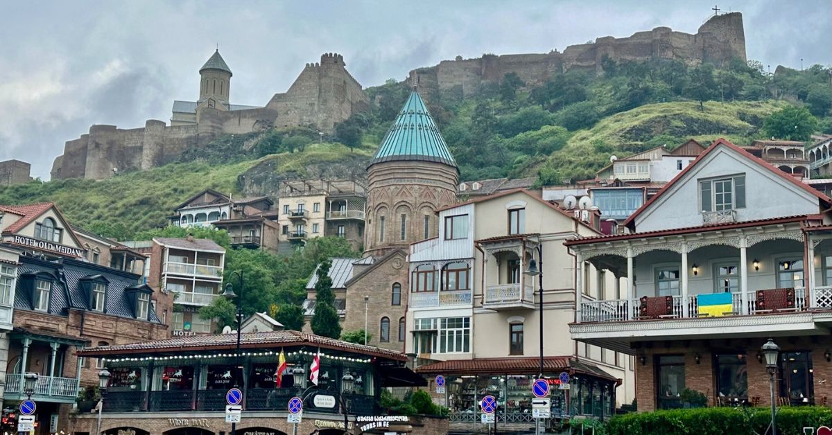 view of old Tbilisi city showing ancient fortress on a hill behind the town.
