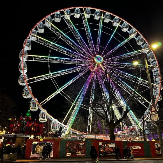 Ferries wheel lit up at night.