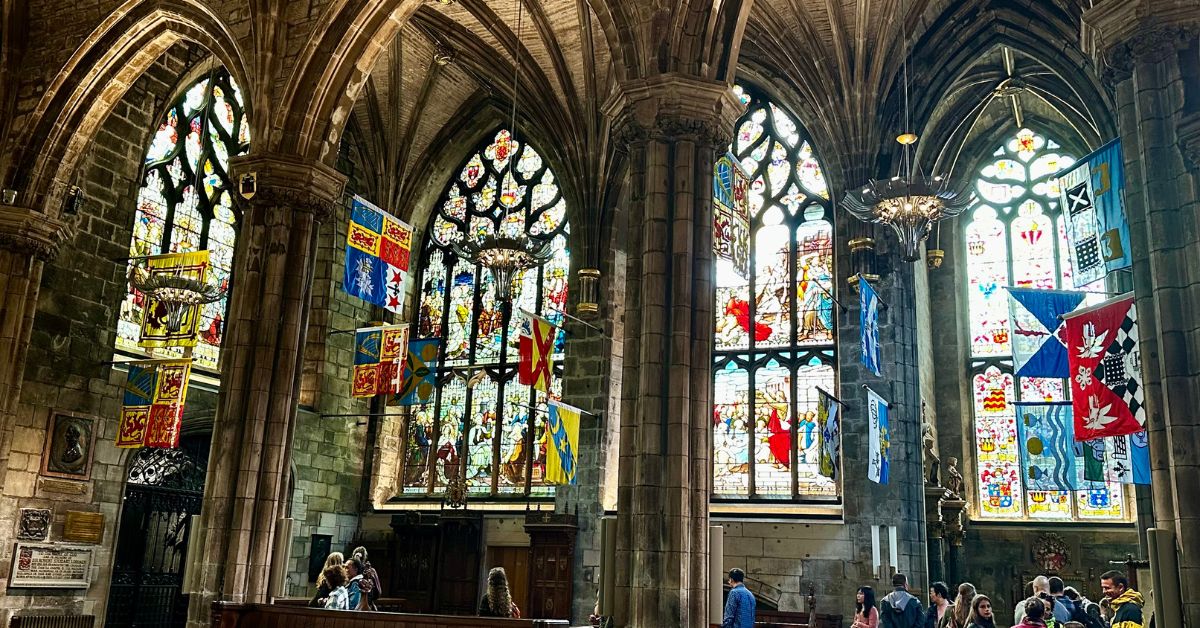 4 large arched stained glass windows within a Scottish cathedral.