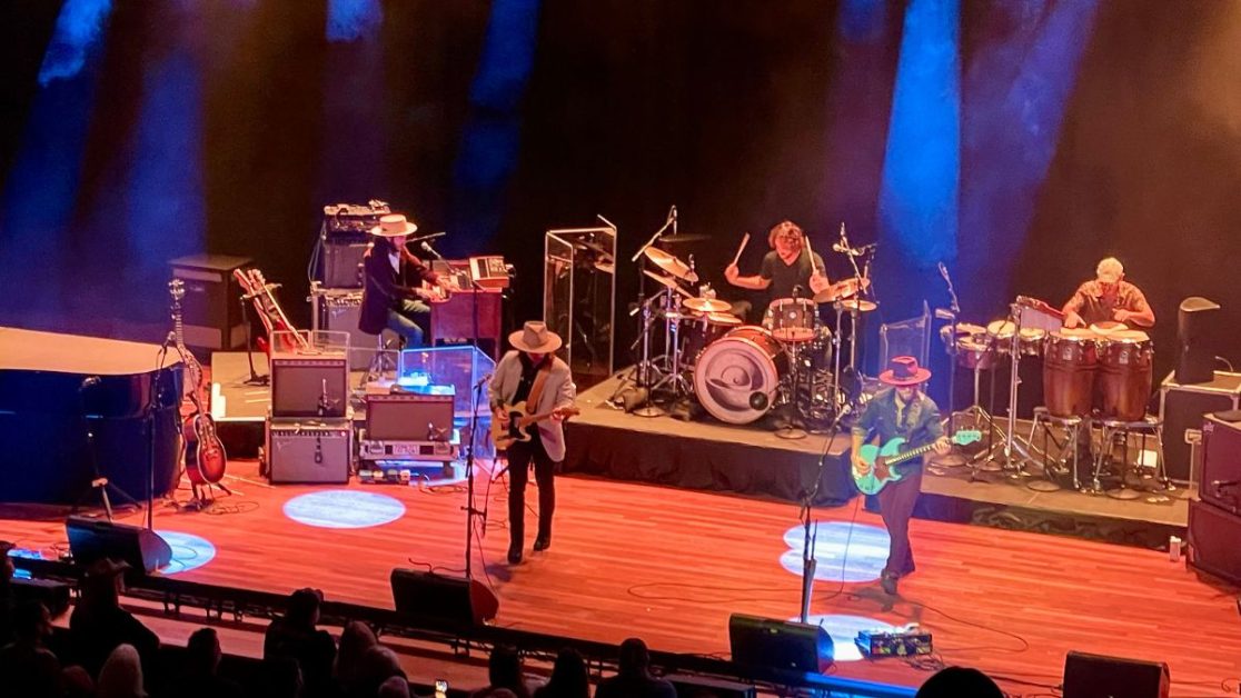 Musicians playing on a stage at Ryman Auditorium.